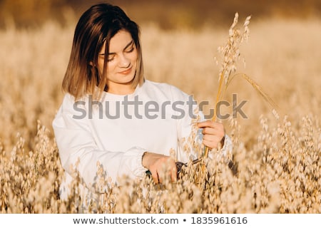 Stock photo: Young Girl With Ears Of Corn In Field