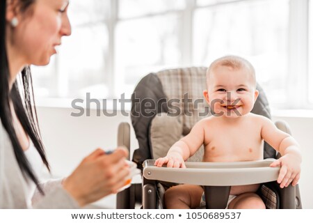 Stock photo: Baby Sit On His Chair Waiting For The Diner Mother Give With Spoon