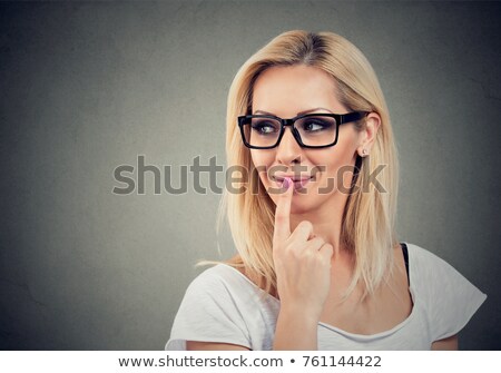 ストックフォト: Smiling Flirting Woman With Finger On Lips Looking Sideways