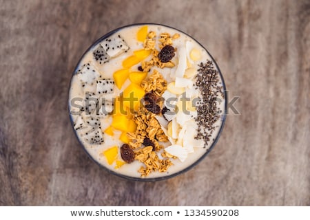 [[stock_photo]]: Smoothie Bowls Made With Mango Banana Granola Grated Coconut Dragon Fruit Chia Seeds And Mint O