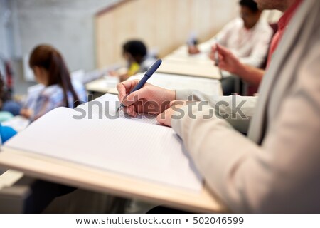 Stock foto: Students With Notebooks At Exam Or Lecture