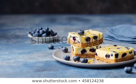Stok fotoğraf: Blueberry Bars Cake Cheesecake On A Grey Plate On Blue Stone Background Top View
