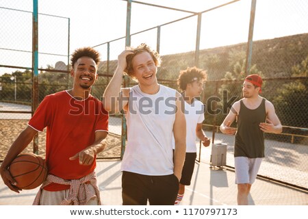 ストックフォト: Photo Of Muscular Sporty Men Smiling And Holding Ball While Stan