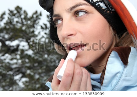 Stock photo: Skier Applying Lip Balm