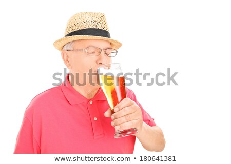 Foto stock: Senior Man Sipping From Pint Glass Beer