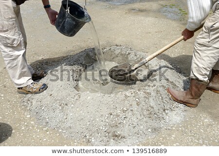 Stockfoto: Two Men Mixing Cement
