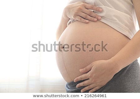 Stockfoto: Pregnant Woman Touching Or Bonding Her Abdomen