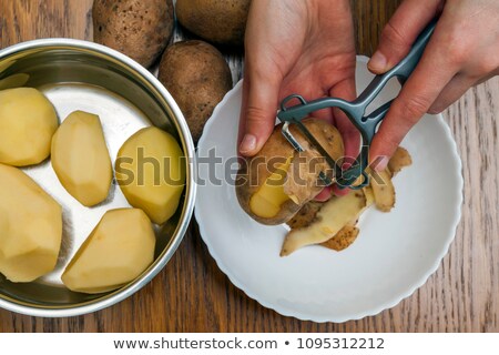 ストックフォト: Potatoes With Peeler And Peeled Skin
