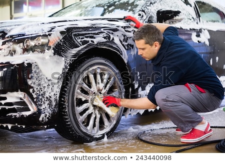 Stock photo: Man Worker Washing Luxury Car On A Car Wash