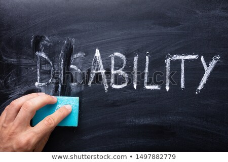 Foto stock: Dis Text Erase With Blue Sponge From Disability Word