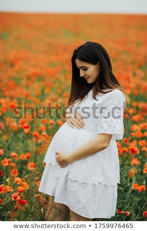 [[stock_photo]]: Pregnant Female Outdoors In Summertime