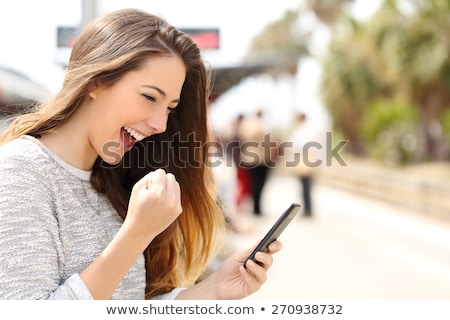 Stock fotó: Young Beautiful Woman Using Her Smart Phone Outdoor