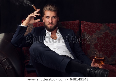 Stok fotoğraf: Cigar In Man Hand With Glass Of Alcohol