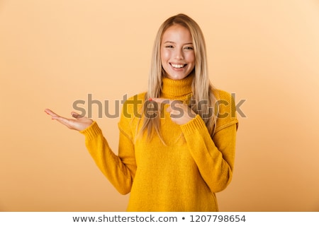 Stok fotoğraf: Portrait Of A Cheerful Young Woman Dressed In Sweater