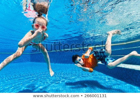 Stock fotó: Kids Having Fun Playing Underwater In Swimming Pool On Summer Vacation