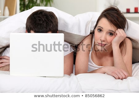 [[stock_photo]]: Tired Woman Wishing Her Boyfriend Would Turn Out The Lights