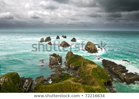 Cliffs Under Thunder Clouds And Turquoise Ocean Stock photo © 3523studio
