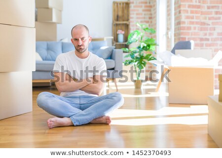 Stockfoto: Grumpy Man Sitting On The Floor