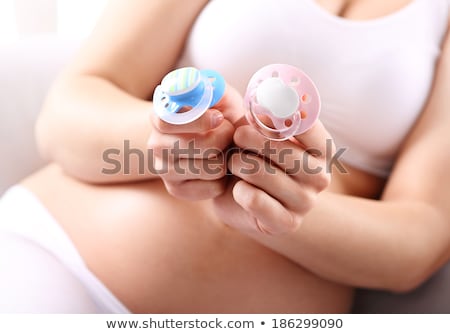 Zdjęcia stock: Pregnant Woman Holding Pacifiers