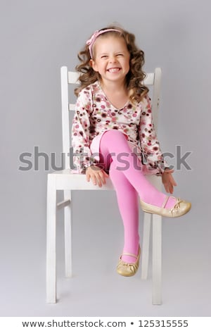 Little Girl Sitting On A Chair In The Studio Stockfoto © PawelSierakowski
