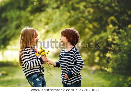 ストックフォト: Boy And Girl Smiling And Giving A Kiss