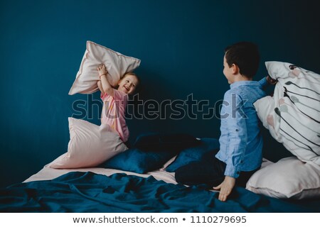 Stock photo: Portrait Of A Funny Girlfriends Fighting With Pillows On Bed