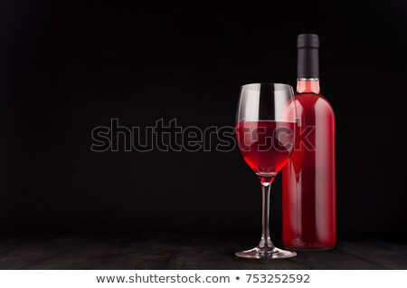 Stockfoto: Bottle Of Rose Wine And Wine Glass Mock Up On Elegant Dark Black Wooden Background Copy Space