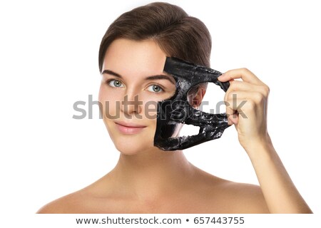 [[stock_photo]]: Woman Removing Peeling Mask From Her Face