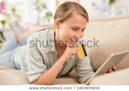 Stockfoto: Young Shopper With Card And Touchpad Scrolling Through Goods In Online Shop