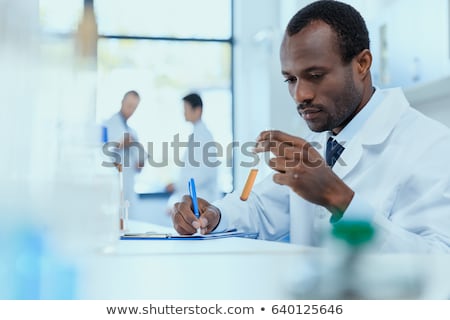 Zdjęcia stock: Scientist Or Medical In Lab Coat Holding Test Tube With Reagent