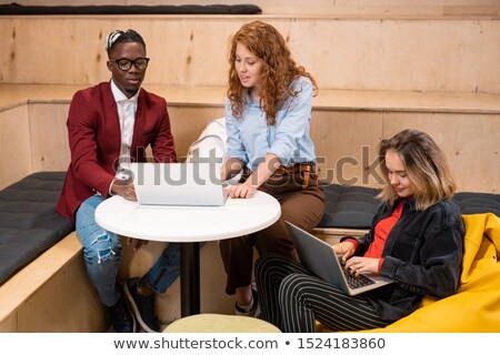 Stock photo: Clever Intercultural Students In Casualwear Making Presentation For Conference