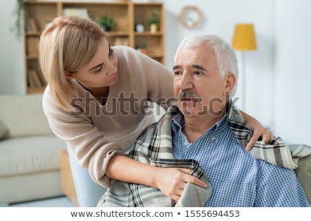 Zdjęcia stock: Careful Daughter Taking Care Of Her Sick Retired Father While Using Tonometer