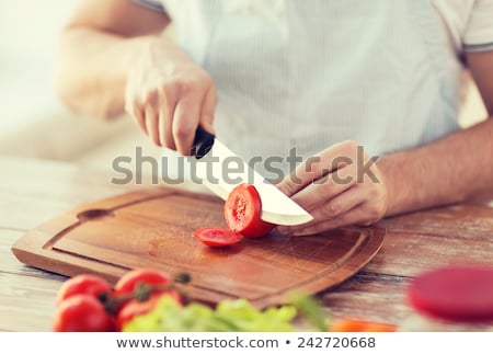 Сток-фото: Closeup Of Hands Cutting Tomatoes