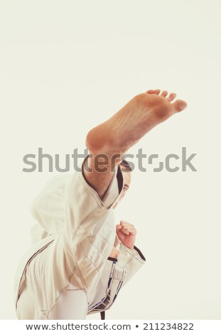 Stock fotó: Man In Kimono Beat A High Leg Kick