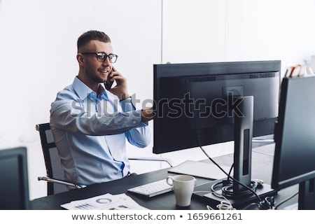 Stok fotoğraf: Cheerful Businessman Talking On The Phone