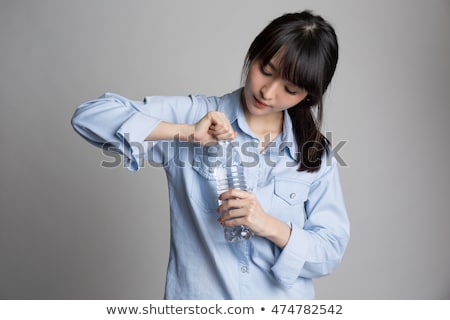 [[stock_photo]]: Businesslady Opens Water Bottle