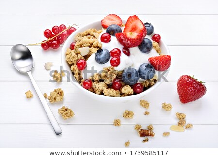 Foto d'archivio: Scoop Of Granola Cereal And Yogurt