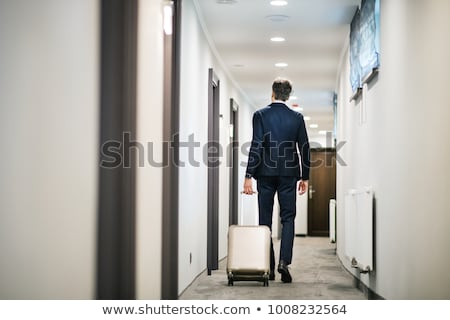 Stockfoto: Businessman Walking In Hotel Room