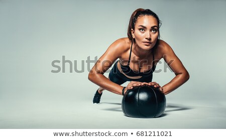 Zdjęcia stock: Young Woman Exercising Push Ups On Medicine Ball