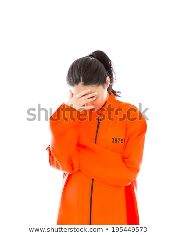 Stockfoto: Upset Young Asian Woman In Prisoners Uniform With Her Hands On Cheek