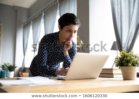 Foto d'archivio: Serious Female Freelancer Working On Laptop Computer
