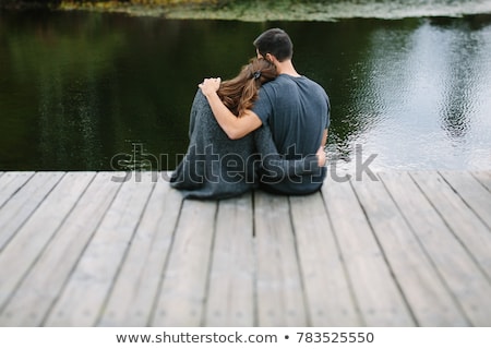 [[stock_photo]]: Couple Sitting On Dock Together