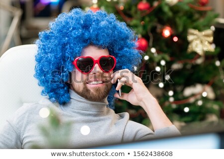 Stok fotoğraf: Happy Office Worker In Sunglasses And Blue Curly Wig Talking By Smartphone