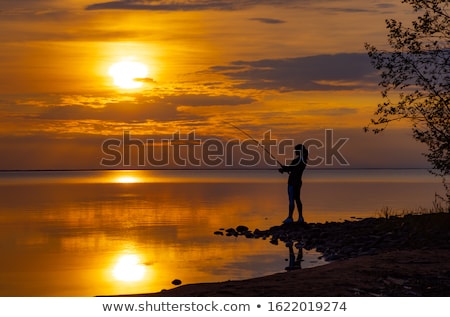 Stockfoto: Woman Fishing On Fishing Rod Spinning In Norway