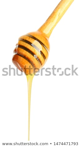 Stockfoto: Honey Dripping From A Wooden Dipper