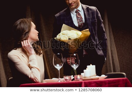 Stock fotó: Fashion Couple Sitting Together On A White Table