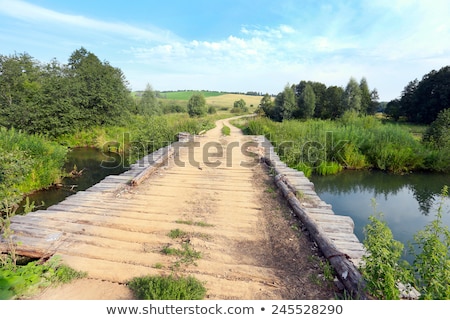 Foto d'archivio: River Water And Small Bridge