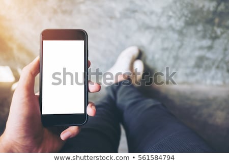 Foto stock: Male Hand Holding Mobile Phone With Blank Mock Up Screen