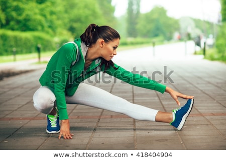 Foto stock: Woman Stretching Legs And Warming Up Before Running