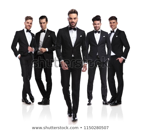 Stockfoto: Relaxed Groom In Black Tuxedo Walks Forward